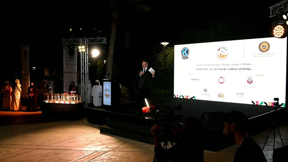 Camera three: a wide shot of the gala stage and LED screen from the side, at the same moment